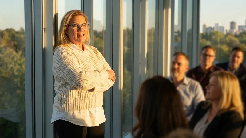 Carol Surbey leading a discussion with a group of business owners in an office